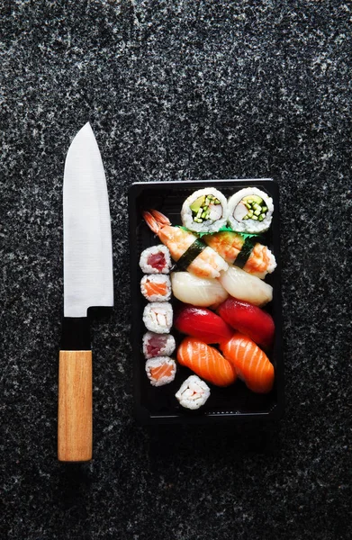 Japanese Lunch Box on the stone. knife for sushi
