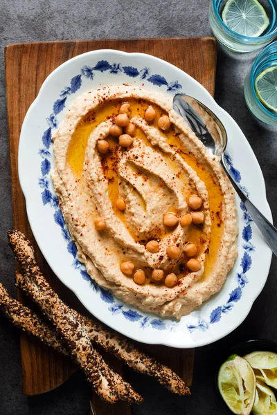 Healthy Homemade Creamy Hummus with Olive Oil  and breadsticks w — Stock Photo, Image