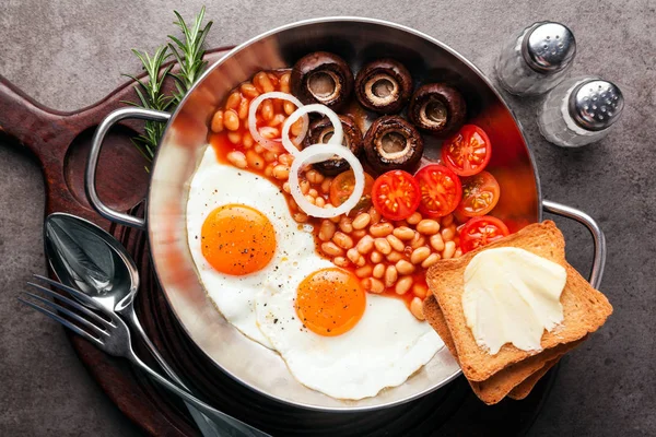 sunny side up Egg with mushrooms, tomatoes and bean in  skillet