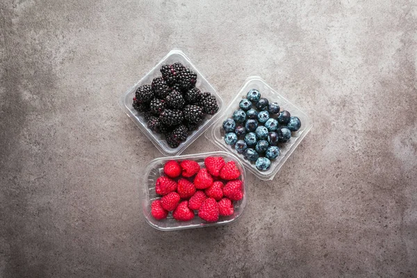 Various fresh summer berries. in plastic containers Top view — Stock Photo, Image