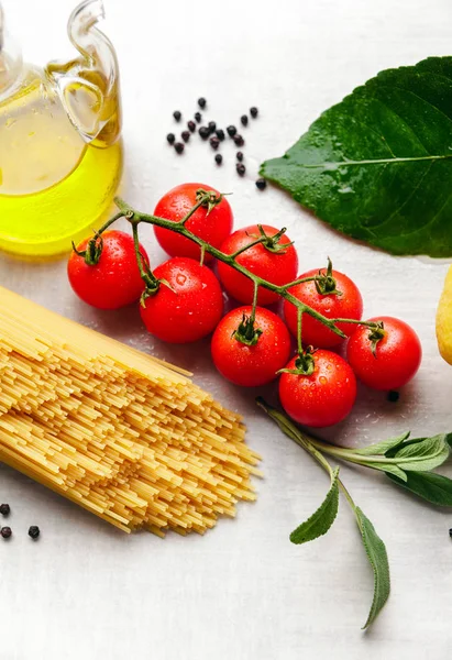 Pasta spaghetti with tomatoes, olive oil, green olives, garlic, Royalty Free Stock Photos