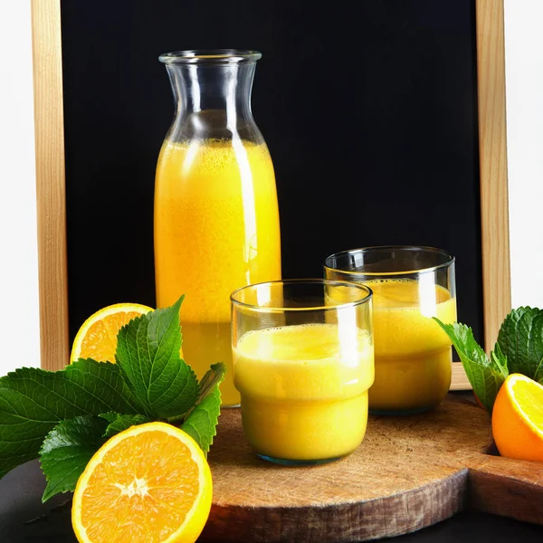 chalk board, and fresh orange juice in glasses and carafe