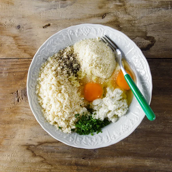 Ingredients in bowl to prepare cheese meatballs — Stock Photo, Image