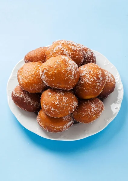 Donuts filled with jam, marmalade or cream on a plate — Stock Photo, Image