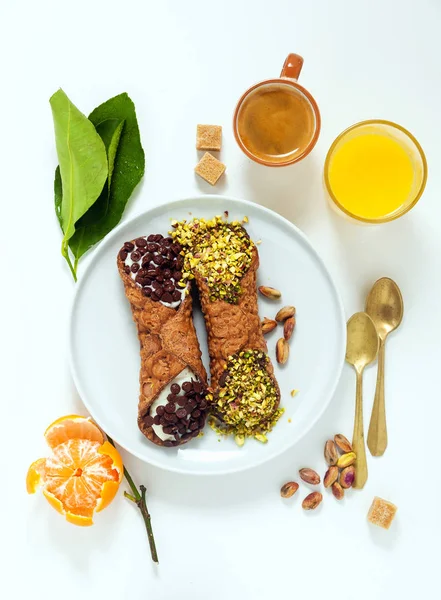 Cannoli with ricotta, chocolate and pistachios. Italian pastries