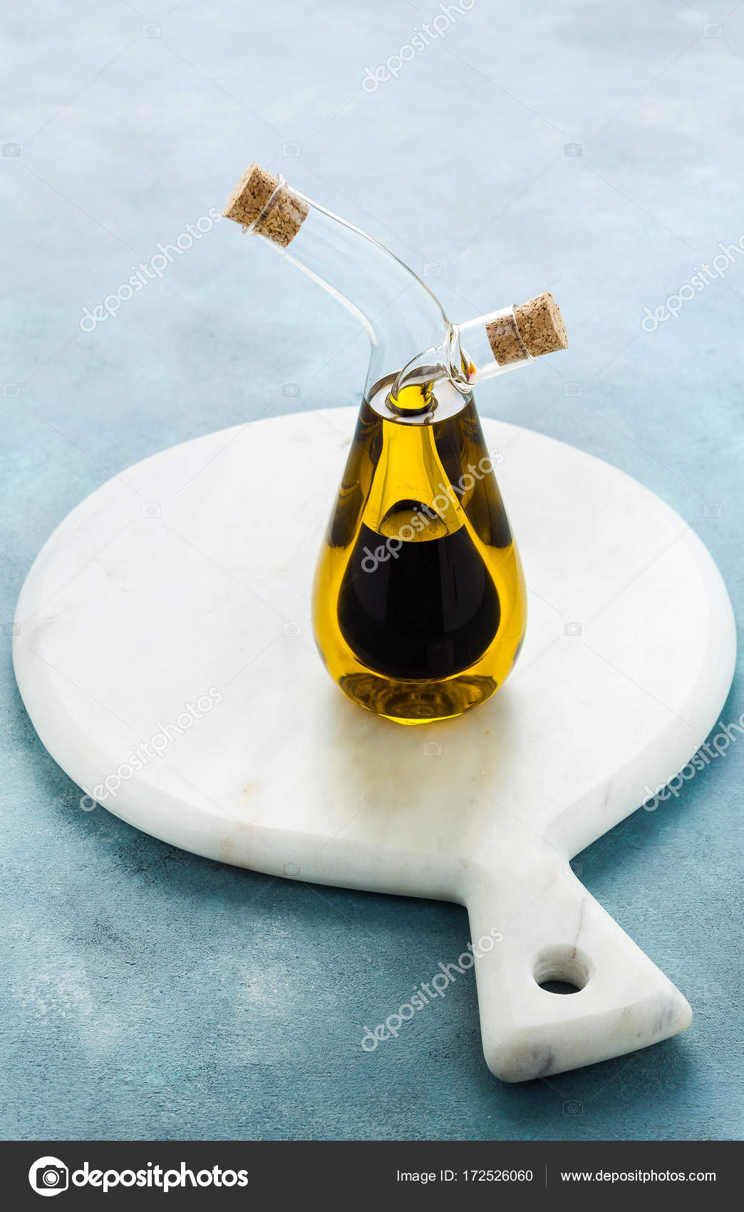 Cruet with olive oil and balsamic vinegar on a blue board Stock Photo by ©IriGri 172526060