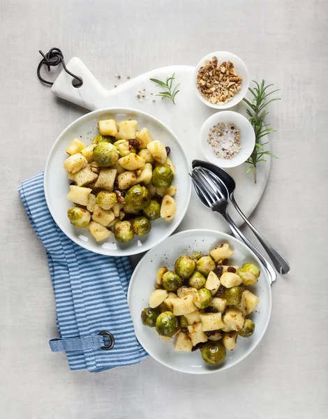 Two plates with Italian gnocchi from potatoes with Brussels spro — Stock Photo, Image
