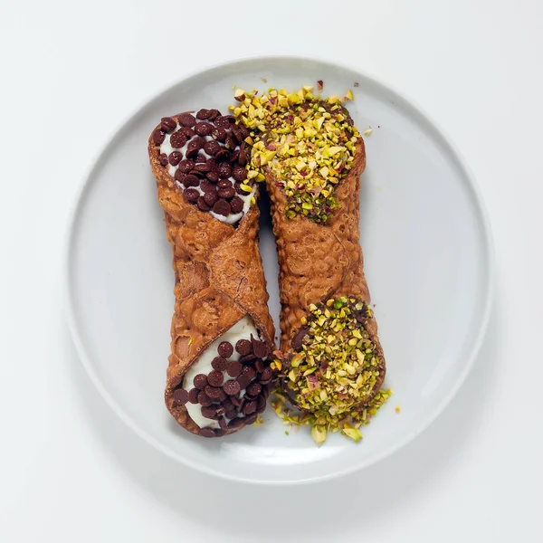 Cannoli with ricotta, chocolate and pistachios. Italian pastries