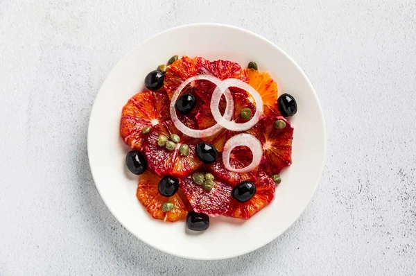 Typical Spanish-style salad of red orange, onion and olives with — Stock Photo, Image