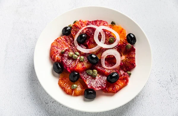 Typical Spanish-style salad of red orange, onion and olives with — Stock Photo, Image