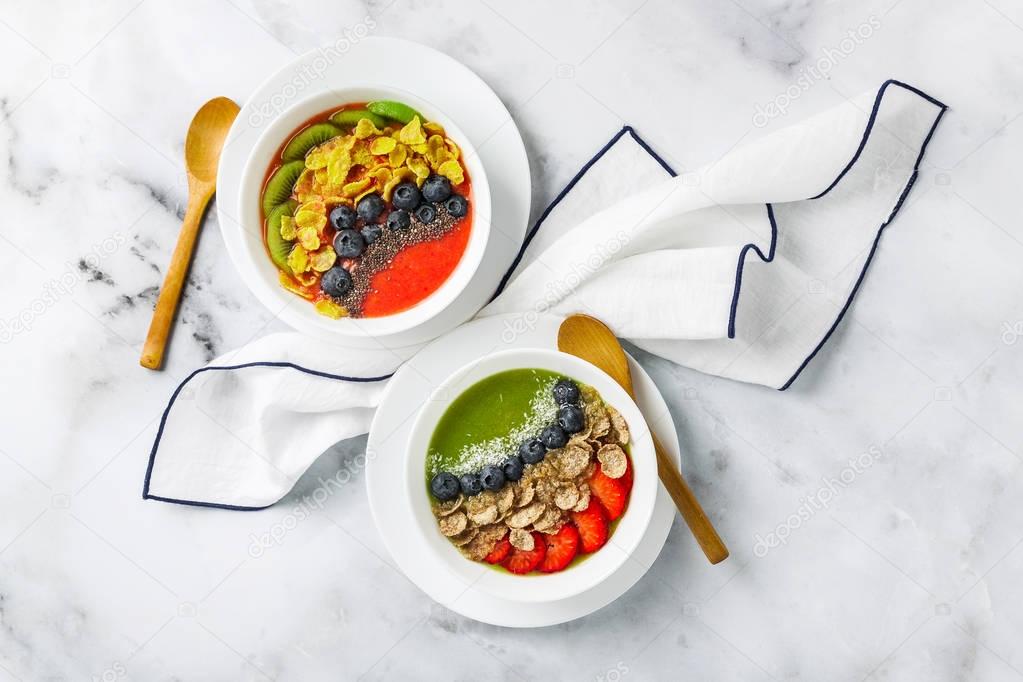 two bowls with different Smoothies from strawberries and kiwi, w