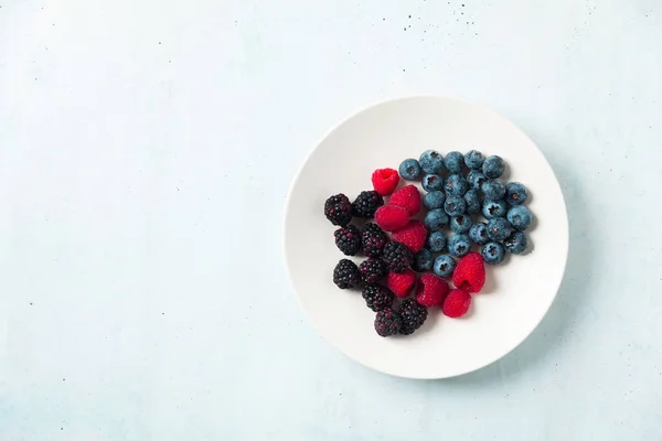 Fruit salad with Various fresh summer berries in white plate . T — Stock Photo, Image