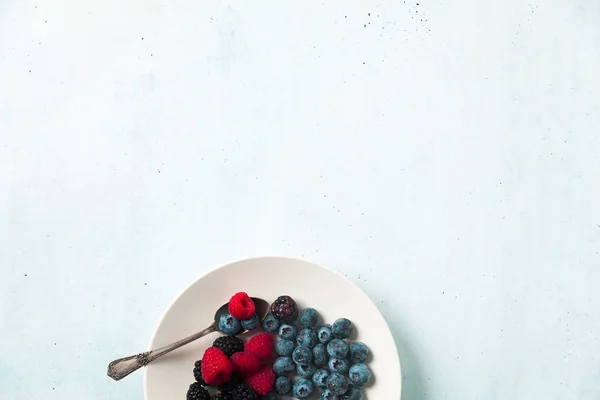 Fruit salad with Various fresh summer berries in white plate . T — Stock Photo, Image