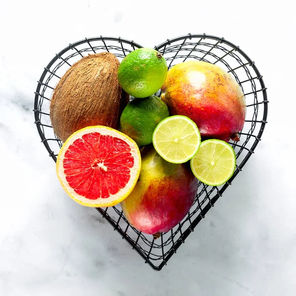 exotic fruits in a basket in the form of a heart. picture from a