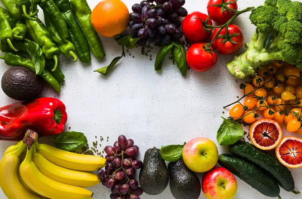 Fresh vegetables and fruits on a white kitchen table. Background for supermarkets, fresh food stores, delivery.