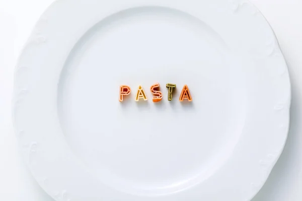 Word Pasta Dry Multi Colored Pasta White Plate — Stock Photo, Image