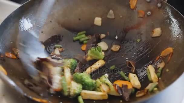 Cocinar verduras fritas profesionales con tofu en el festival de comida callejera. Proceso de cocción de cerca . — Vídeo de stock