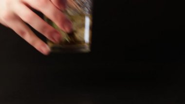 Barmen ancohol ve buz ile cam koyarak. Bir el kadar bir içki alır.