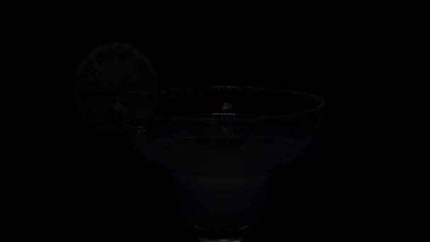 Margarita cocktail on black background. — Stock Video