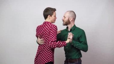 Romantic couple dancing on white background. Man and woman are dancing slow blues dance. Sensual couple dancing.