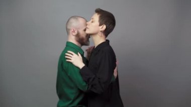 Romantic couple dancing on gray background. Man and woman are dancing slow blues dance. Sensual couple dancing.