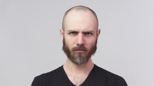 Strict man raising finger in warning gesture over white background. Serious dissatisfied man making admonishing gesture, disapproval sign, saying no. — Stock Video