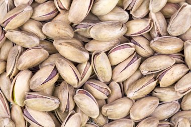 close up of pistachios in shells as background