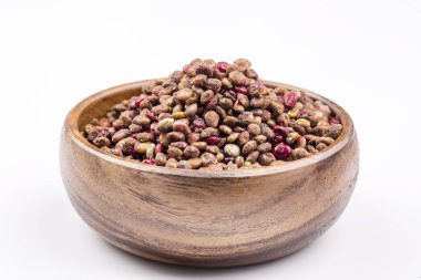 bowl of dry mixed peppers on white background