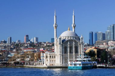 the mosque in the city with blue sky background