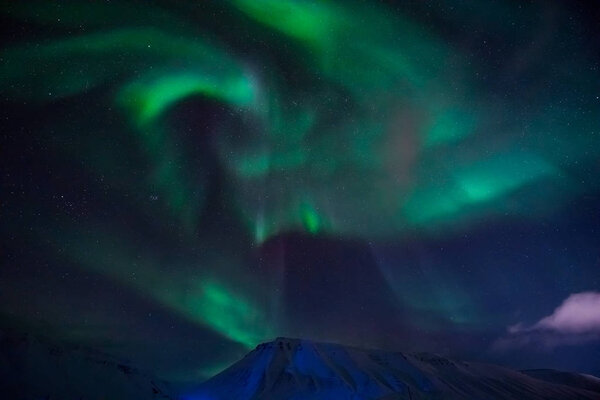 The polar Northern lights in Norway Svalbard in the mountains