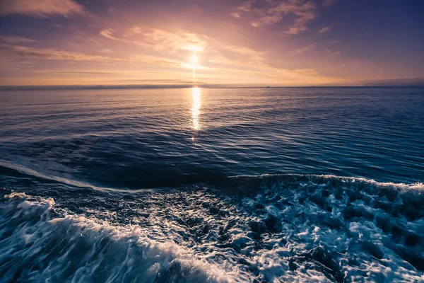 Deniz okyanus dalgalarının Svalbard Spitsbergen adalar Longyearbyen kıyısında pembe turuncu günbatımı manzara