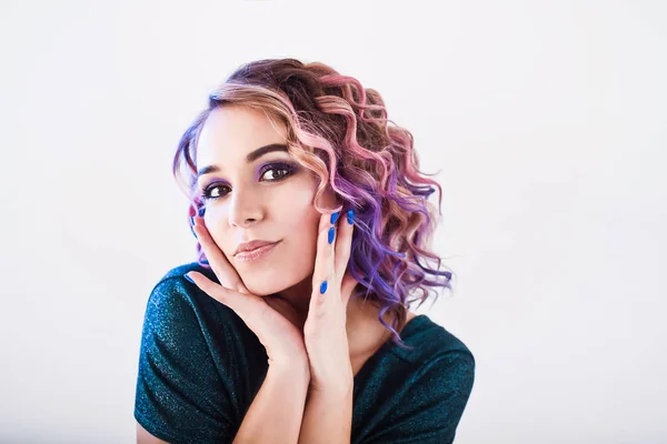 Close-up portrait in studio isolated beautiful sexy young blond hipster girl with lilac and pink hair posing with tooth smile Stock Picture