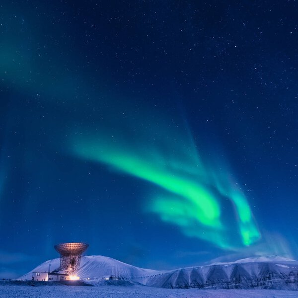 The polar arctic Northern lights aurora borealis sky star in Norway Svalbard in Longyearbyen the moon mountains