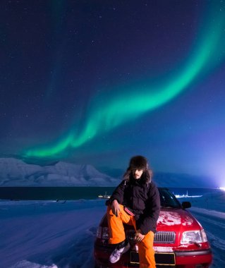 Kutup kutup kuzey ışıkları aurora borealis gökyüzü ay Dağları Longyearbyen City'de Norveç Svalbard adamla içinde yıldız