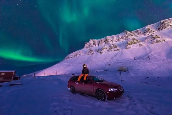 The polar arctic Northern lights aurora borealis sky star in Norway Svalbard man in Longyearbyen city the moon mountains