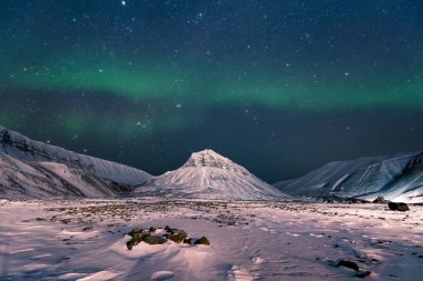 The polar arctic Northern lights hunting aurora borealis sky star  track in Norway travel   Svalbard in Longyearbyen city the  mountains clipart