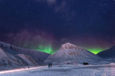 The polar arctic Northern lights hunting aurora borealis sky star in Norway travel photographer man Svalbard in Longyearbyen city the moon mountains clipart
