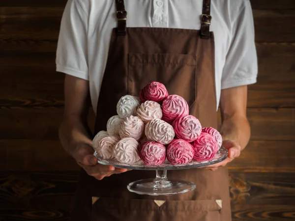 Güzel pembe Zefir (Zephyr, zephir) - Lokum gibi şekerlemeler - Fırıncılar ellerinde şeffaf bir plaka üzerinde