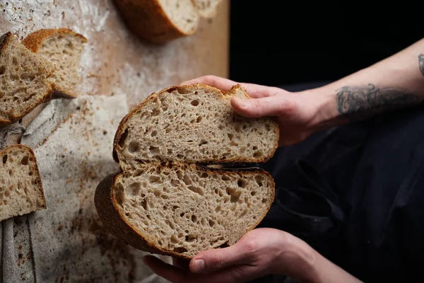 artisan sourdough bread cut (High Hydration Sourdough Bread). baker holding a loaf of bred
