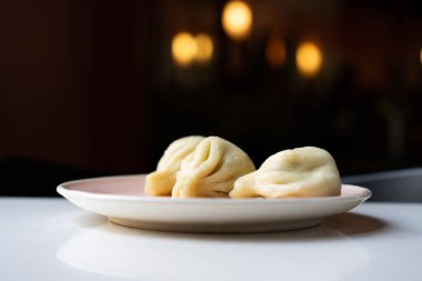 Georgian cuisine: beautiful khinkali on a plate in a restaurant