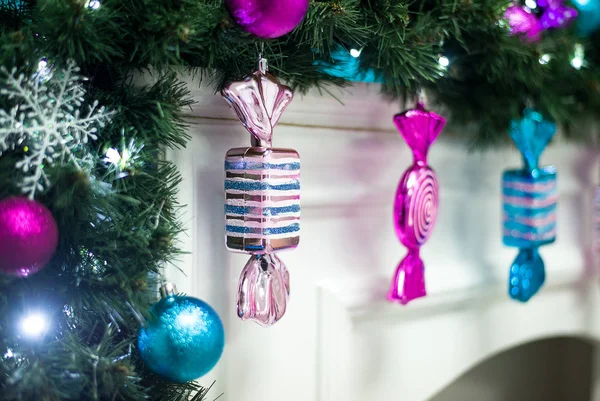 Glass Christmas candy hanging on the mantelpiece — Stock Photo, Image