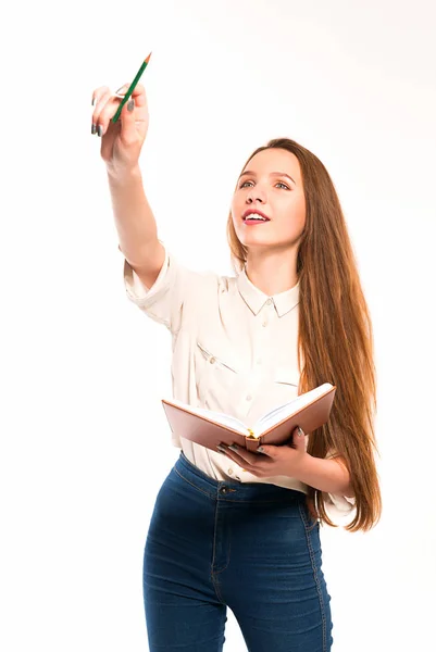 Jeune fille avec crayon et livre dans les mains — Photo