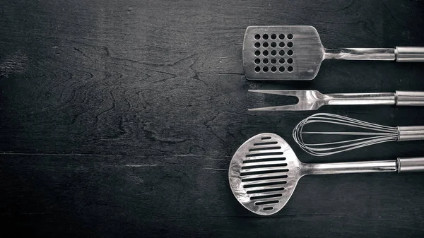 Kitchen tools. On Wooden background.