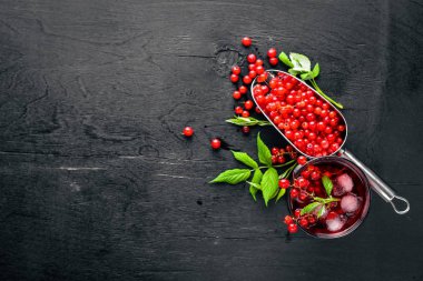 Ahşap arka plan üzerinde buz ile taze kırmızı kuş üzümü kokteyl. Üstten Görünüm. Boş alan.