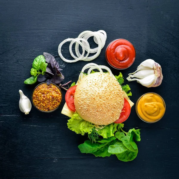 Ahşap arka plan üzerinde peynir, et ve yeşil soğan ile hamburger. Üstten Görünüm. Boş alan.