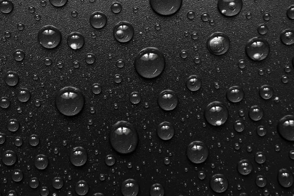 Gotas de agua sobre fondo negro. Macro . — Foto de Stock