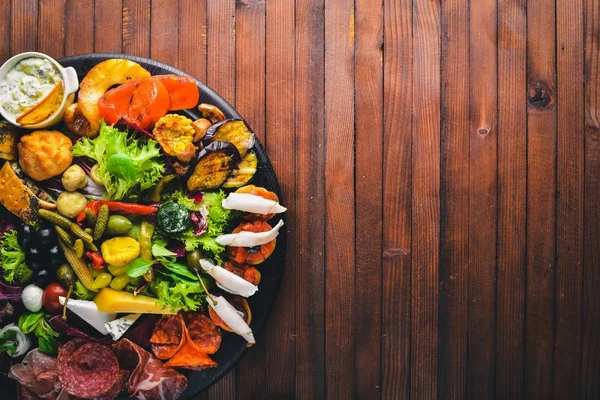 Turşu sebze ve et aperatifler ayarlayın. İtalyan mutfağı. Üstten Görünüm. Ahşap arka plan üzerinde.