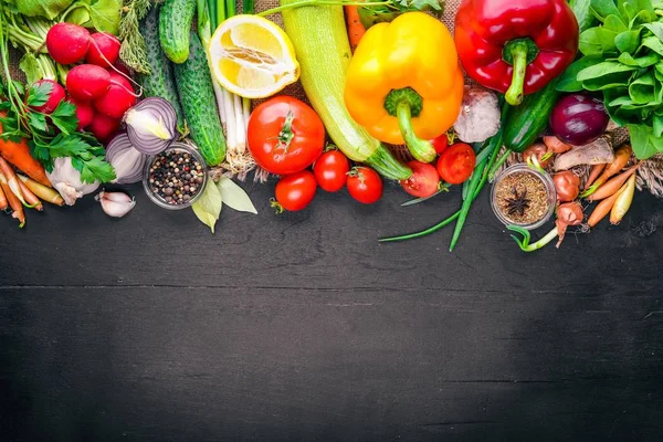 Marco de alimentos orgánicos. Verduras y especias frescas crudas. En una pizarra de madera . — Foto de Stock