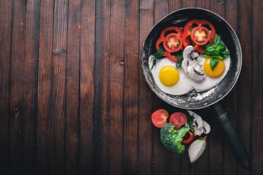 Sahanda yumurta ile bir tavada sebze ve otlar. Üstten Görünüm. Boş alan.