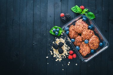 Yulaf ezmeli kurabiye fındık ve bal ile. Sağlıklı bir diyet yemek. Siyah ahşap arka plan üzerinde. Üstten Görünüm. Metin için boş alan.